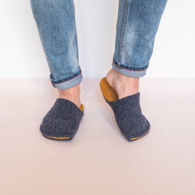 A man wearing navy blue and curcuma yellow slippers